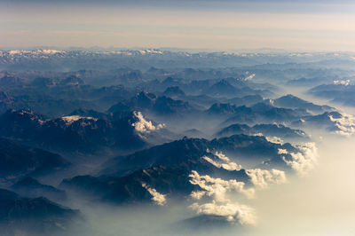 Aerial view of mountains against sky during sunrise