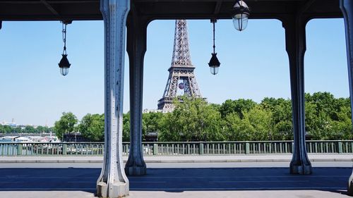 Eiffel tower seen from road against sky