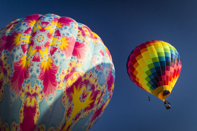 Low angle view of hot air balloons flying in sky