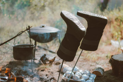 Camping in nature after a hike, cooking in a pot over a fire, drying shoes. tourist weekends