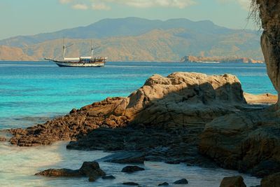 Scenic view of sea and mountains against sky