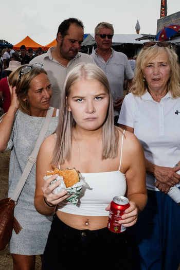 PORTRAIT OF A YOUNG WOMAN WITH PEOPLE