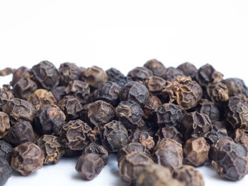 Close-up of roasted coffee beans against white background