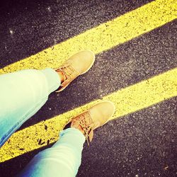 Low section of man walking on road