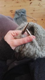 High angle view of woman knitting sweater