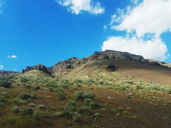 Scenic view of mountains against blue sky