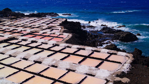 Salt flats farms showing red pink water and white rock sea salt in la palma canary island 