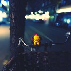 Toy on bicycle handlebar at night