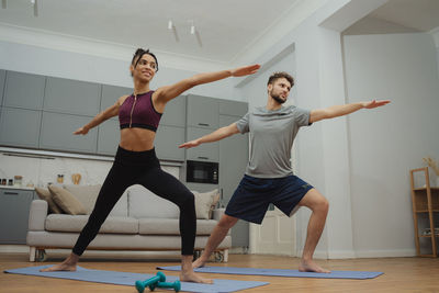 Full length of woman exercising in gym