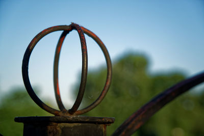 Close-up of rusty metal against sky