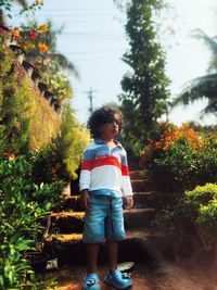 Rear view of man walking on footpath