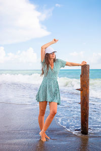 Full length of woman at beach against sky