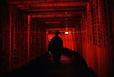 Rear view of man walking in corridor