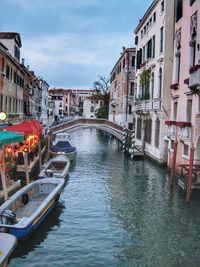 View of canal amidst buildings in city