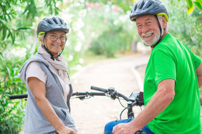 Smiling man with woman on bicycle