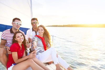 People enjoying in sea against sky