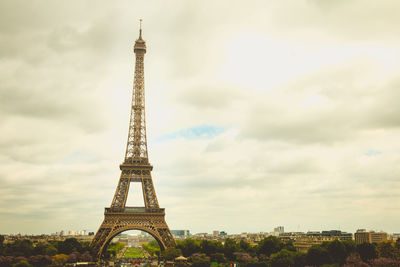 Tower of building against cloudy sky