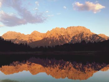 Scenic view of lake by mountains against sky