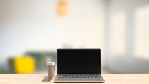 Close-up of coffee cup on table