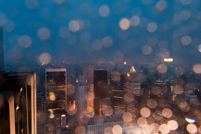 Illuminated cityscape against sky at night