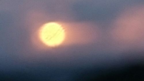 Low angle view of moon at sunset