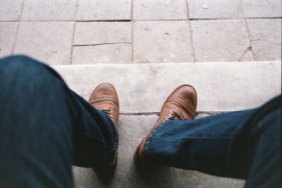 Low section of man standing on footpath