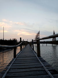 View of bridge over river against cloudy sky