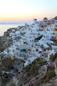 High angle view of buildings in city at sunset