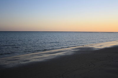Scenic view of sea against clear sky during sunset