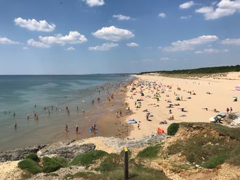 High angle view of people at beach against sky