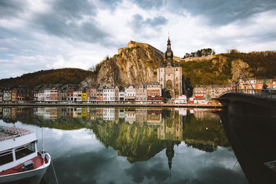 Reflection of building on lake against sky