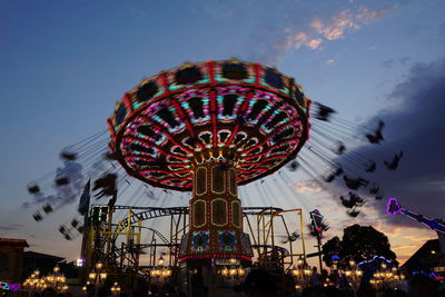 Low angle view of illuminated ferris wheel against sky at night