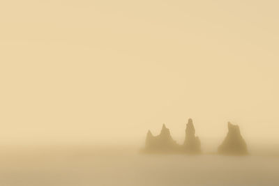 Silhouette of sea against sky during sunset