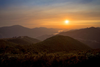 Scenic view of mountains against sky during sunset