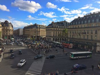 View of city street against cloudy sky