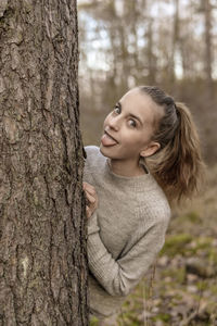 Portrait of a smiling young woman in forest