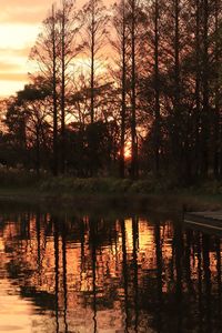 Scenic view of lake against orange sky