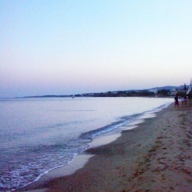 water, sea, beach, copy space, clear sky, tranquil scene, shore, scenics, tranquility, beauty in nature, sand, nature, horizon over water, incidental people, wave, sky, coastline, idyllic, vacations