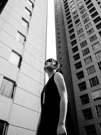 Low angle view of woman standing in front of building