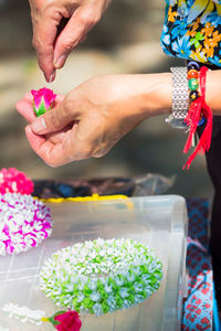 Close-up of woman making flower bouquet