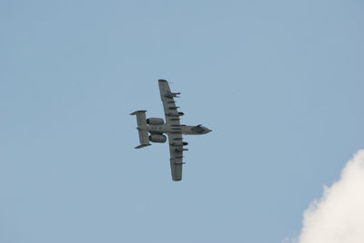 Low angle view of airplane flying in sky