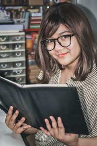 Portrait of young woman using phone