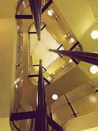 Low angle view of illuminated lighting equipment hanging on ceiling