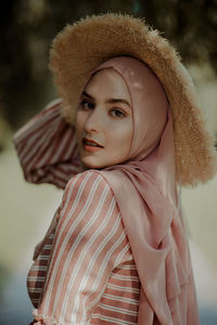 Portrait of young woman wearing hat