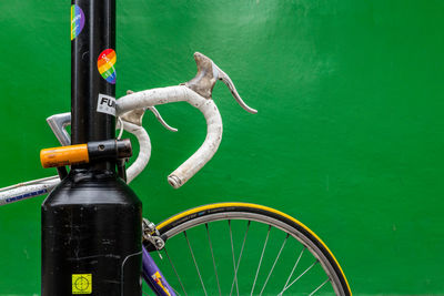 Close-up of bicycle wheel against wall