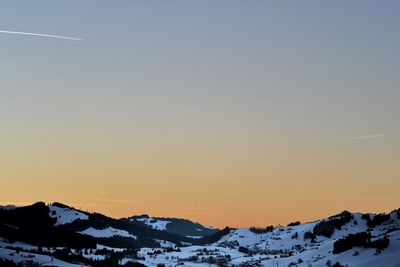 Scenic view of snowcapped mountains against clear sky