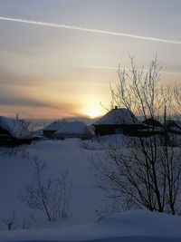 Scenic view of snow covered landscape against sky during sunset