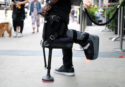 Low section of man walking on street