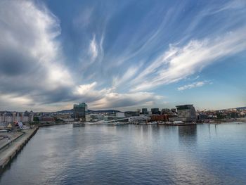 River by buildings against sky in city