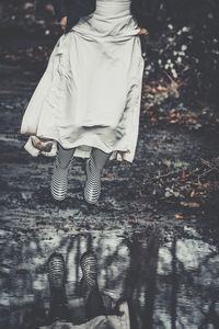 Low section of woman walking on street